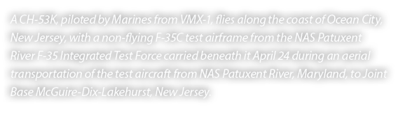 A CH 53K, piloted by Marines from VMX 1, flies along the coast of Ocean City, New Jersey, with a non flying F 35C tes...
