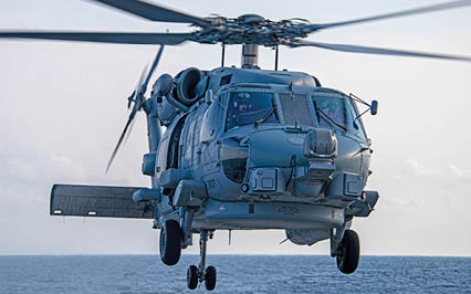 An MH-60R helicopter attached to the “Spartans” of Helicopter Maritime Strike Squadron (HSM) 70, embarked on the USS Gerald R. Ford (CVN 78), hoovers over the fantail of the guided-missile destroyer USS Arleigh Burke (DDG 51) Sept. 5, 2020 during Deck Landing Qualifications. Burke is underway in the Atlantic Ocean conducting basic phase training evolutions. (U.S. Navy photo by Mass Communication Specialist Seaman Riley McDowell)