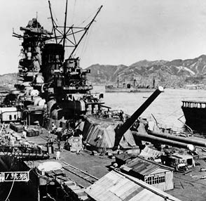(Japanese battleship, 1941-1945) In the late stages of construction alongside the large fitting out pontoon at the Kure Naval Base, Japan, 20 September 1941. The aircraft carrier Hosho is at the extreme right. The store ship Mamiya is in the center distance. Note Yamato's after 460mm main battery gun turret, and superfiring 155mm secondary battery gun turret.  Courtesy of Lieutenant Commander Shizuo Fukui.  U.S. Naval History and Heritage Command Photograph.