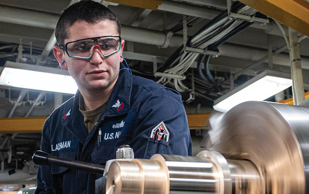 240604-N-ER894-1095 PHILIPPINE SEA (June 4, 2024) Machinery Repairman 1st Class Adam Lachman, from East Meadow, New York, operates a lathe to turn a piece of steel in the machine repair shop aboard the U.S. Navy’s only forward-deployed aircraft carrier, USS Ronald Reagan (CVN 76), in the Philippine Sea, June 4. Ronald Reagan, the flagship of Carrier Strike Group 5, provides a combat-ready force that protects and defends the United States, and supports alliances, partnerships and collective maritime interests in the Indo-Pacific region. (U.S. Navy photo by Mass Communication Specialist 2nd Class Timothy Dimal)