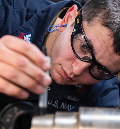 240604-N-ER894-1073 PHILIPPINE SEA (June 4, 2024) Machinery Repairman 1st Class Adam Lachman, from East Meadow, New York, uses a micrometer to measure a piece of steel before operating a lathe in the machine repair shop aboard the U.S. Navy’s only forward-deployed aircraft carrier, USS Ronald Reagan (CVN 76), in the Philippine Sea, June 4. Ronald Reagan, the flagship of Carrier Strike Group 5, provides a combat-ready force that protects and defends the United States, and supports alliances, partnerships and collective maritime interests in the Indo-Pacific region. (U.S. Navy photo by Mass Communication Specialist 2nd Class Timothy Dimal)
