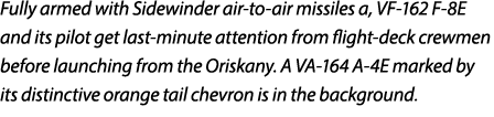 Fully armed with Sidewinder air to air missiles a, VF 162 F 8E and its pilot get last minute attention from flight de...
