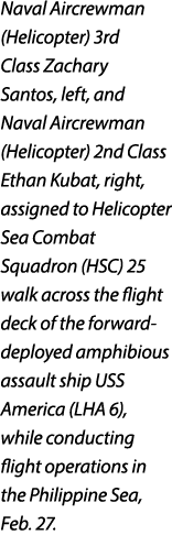 Naval Aircrewman (Helicopter) 3rd Class Zachary Santos, left, and Naval Aircrewman (Helicopter) 2nd Class Ethan Kubat...