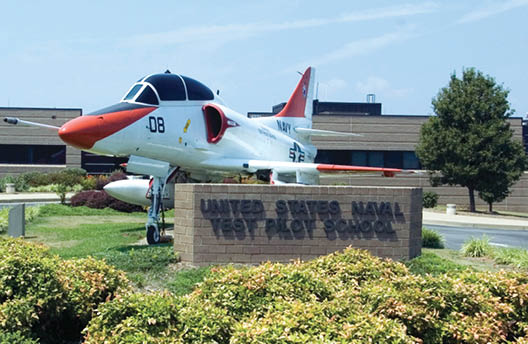 050802-N-0295M-177 Patuxent River, Md. (Aug. 2, 2005)  A TA-4J Skyhawk attack aircraft sits in front of the main administration building at the United States Naval Test Pilot School (USNTPS), on board Naval Air Station Patuxent River. USNTPS provides instruction to experienced pilots, flight officers, and engineers in the processes and techniques of aircraft and systems test and evaluation. The school investigates and develops new flight test techniques, publishes manuals for use of the aviation test community for standardization of flight test techniques and project reporting and conducts special projects. USNTPS operates approximately 50 aircraft of 13 types. U.S. Navy photo by Photographer s Mate 2nd Class Daniel J. McLain (RELEASED)  