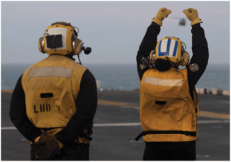 ATLANTIC OCEAN (April 5, 2025) Aviation Boatswain’s Mate (Handling) 3rd Class Gerald Manful, left, and Aviation Boatswain’s Mate (Handling) Airman Rigio Carpea, both assigned to the amphibious assault ship USS Wasp (LHD 1), signal to a pilot aboard an MH-53E Sea Dragon, assigned to the “Blackhawks” of Helicopter Mines Countermeasures Squadron 15 (HM-15), to land on the ship’s flight deck during flight operations, April 5, 2025. Wasp is underway conducting routine operations in the Atlantic Ocean. (U.S. Navy photo by Mass Communication Specialist Seaman Savannah Lujan)