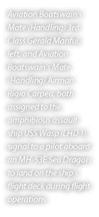 Aviation Boatswain’s Mate (Handling) 3rd Class Gerald Manful, left, and Aviation Boatswain’s Mate (Handling) Airman R...
