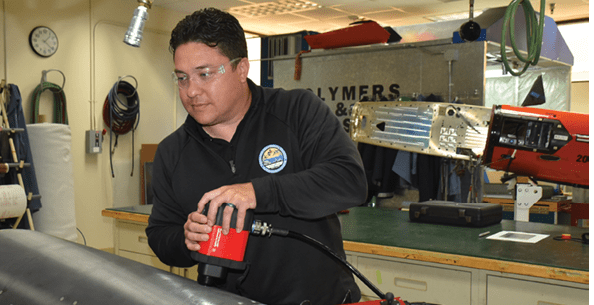 FRCSW engineer Dr. Justin Massey demonstrates composite damage assessment using advanced inspection technology. Massey, whose innovations in composite repair have saved the Navy millions, is departing FRCSW for a new role with the Office of Naval Research in Japan.