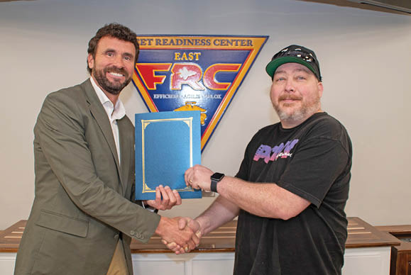 James Tutor, right, of Fleet Readiness Center East's Maintenance, Repair and Overhaul Logistics Department, earned recognition for his Beneficial Suggestion with an award presented by Department Head Jody Carey.