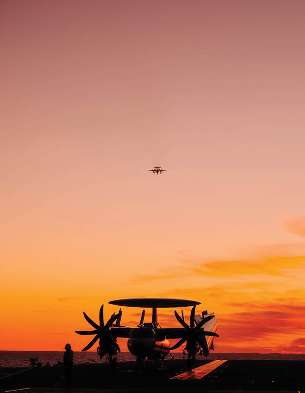An E-2D Hawkeye attached to Airborne Command and Control Squadron (VAW-120) flies away from Nimitz-class aircraft carrier USS George Washington (CVN 73) after performing a touch and go Jan. 14, 2024. George Washington is underway in support of carrier qualifications. (U.S. Navy photo by Mass Communication Specialist 3rd Class August Clawson)