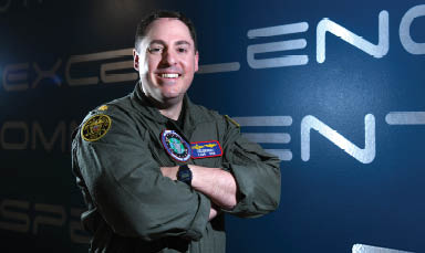 U.S. Navy Lt. Cdr. Matthew Dring, National Space Defense Center operations integrations chief, poses for a photo at Schriever Space Force Base, Colo., April 18, 2025. Dring was selected as one of the first Navy officers to attend the weapons instructor course at the U.S. Air Force Weapons School’s 328th Weapons Squadron. (U.S. Space Force photo by Tiana Williams)