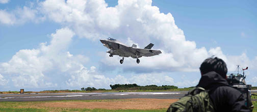 250525-N-NA545-1007 IWO TO, Japan (May 25, 2025) A Japanese media representative captures a U.S. Navy F-35C Lightning II, assigned to Strike Fighter Squadron (VFA) 147 and attached to Carrier Air Wing (CVW) 5, as the aircraft conducts a “touch-and-go” during a field carrier landing practice (FCLP) at Iwo To, Japan, May 25, 2025. FCLP is a required flight training for pilot qualification and proficiency that precedes aircraft carrier landing operations, ensuring warfighting readiness in  support of regional security and stability in the U.S. Indo Pacific region. (U.S. Navy photo by Mass Communication Specialist 2nd Class Dyxan K. Williams)