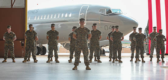 U.S. Marines with Marine Transport Squadron 1 (VMR-1), 4th Marine Aircraft Wing stand in formation during a Full Operational Capability ceremony at Naval Air Station Joint Reserve Base, Fort Worth, Texas on June 18, 2025. The Full Operational Capability ceremony is to celebrate VMR-1 becoming fully operational with 5 fully qualified C-40A crews and a full composite of ground and logistic support staff. (U.S. Marine Corps photo by Lance Cpl. Abram Maestre)