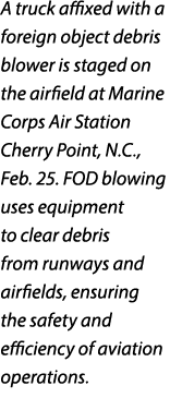 A truck affixed with a foreign object debris blower is staged on the airfield at Marine Corps Air Station Cherry Poin...