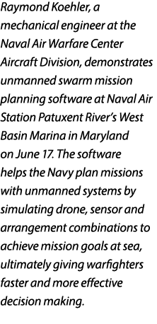 Raymond Koehler, a mechanical engineer at the Naval Air Warfare Center Aircraft Division, demonstrates unmanned swarm...