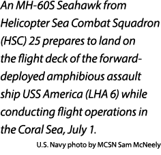 An MH 60S Seahawk from Helicopter Sea Combat Squadron (HSC) 25 prepares to land on the flight deck of the forward dep...