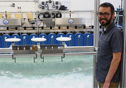 U.S. Naval Research Laboratory (NRL)-National Research Council (NRC) Postdoctoral Fellow with NRL’s Chemistry Division, Center for Corrosion Science and Engineering, Alex Johnson, next to symmetric airfoils used for measuring dry deposition of chloride and sulfate. This is used to study the impact of corrosion from saltwater aerosols at the NRL Laboratory for Autonomous Systems Research (LASR) Littoral Bay Wave Pool, in Washington, D.C., Sept. 24, 2024. RELEASED
