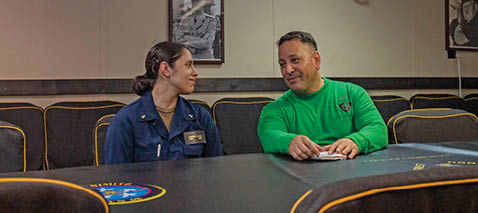From left, Aviation Machinist's Mate Senior Chief Dan Reyes and his daughter, U.S. Midshipmen 2nd Class Gabriella Reyes, from Miami, Florida sit in the Chiefs Mess of the aircraft carrier USS Nimitz (CVN 68) in the South China Sea, June 11, 2025. Nimitz is underway in the U.S. 7th Fleet area of operations on a scheduled deployment, demonstrating the U.S. Navy's unwavering commitment to a free and open Indo-Pacific. (U.S. Navy Photo by Mass Communication Specialist Seaman Apprentice Frankie M. Guage)