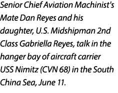 Senior Chief Aviation Machinist's Mate Dan Reyes and his daughter, U.S. Midshipman 2nd Class Gabriella Reyes, talk in...