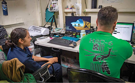 From left, U.S. Midshipmen 2nd Class Gabriella Reyes, from Miami, Florida observes her father, Aviation Machinist's Mate Senior Chief Dan Reyes during the work day aboard the aircraft carrier USS Nimitz (CVN 68) in the South China Sea, June 11, 2025. Nimitz is underway in the U.S. 7th Fleet area of operations on a scheduled deployment, demonstrating the U.S. Navy's unwavering commitment to a free and open Indo-Pacific. (U.S. Navy Photo by Mass Communication Specialist Seaman Apprentice Frankie M. Guage)