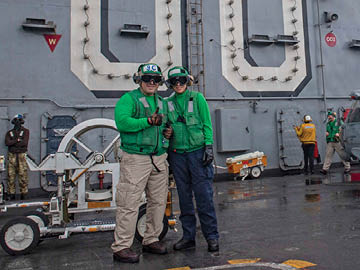 From left, Aviation Machinist's Mate Senior Chief Dan Reyes and his daughter, U.S. Midshipmen 2nd Class Gabriella Reyes, from Miami, Florida, pose for a photo on the flight deck aboard the aircraft carrier USS Nimitz (CVN 68) in the South China Sea, June 11, 2025. Nimitz is underway in the U.S. 7th Fleet area of operations on a scheduled deployment, demonstrating the U.S. Navy's unwavering commitment to a free and open Indo-Pacific. (U.S. Navy Photo by Mass Communication Specialist Seaman Apprentice Frankie M. Guage)