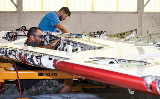 250327-N-DG679-1057  JACKSONVILLE, Fla. (March 27, 2025) Kristopher Williams (left) and Jeffrey Zumwalde, sheet metal mechanics at Fleet Readiness Center Southeast, perform service life extension program upgrades on a T-45 Goshawk wing. The T-45 jet aircraft is used for intermediate and advanced portions of the Navy/Marine Corps pilot training program.  (U.S. Navy photo by Toiete Jackson)