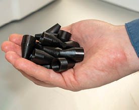 Fleet Readiness Center East Innovation Lab Lead Engineer Jeremy Bunting displays a handful of an F-35 O-ring installation tool recently manufactured by the lab. The two-person team at the Innovation Lab used additive manufacturing – commonly referred to as 3D printing – to fulfill a critical request for 2,000 tools, and successfully completed the order under two weeks. Within days, the effort put tools in aircraft maintainers’ hands across the U.S. Marine Corps, Navy and Air Force. The turnaround time represented less than 10% of the estimated six months procurement would have taken through traditional acquisition methods. (Photo by Heather Wilburn, Fleet Readiness Center East)