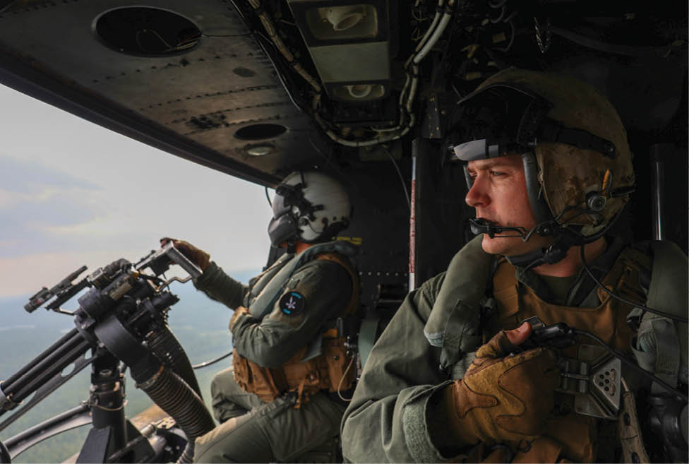 U.S. Marine Corps Staff Sgt. Justin Gilstrap, a weapons and tactics instructor crew chief with Marine Light Attack Helicopter Squadron 775, Marine Aircraft Group 41, 4th Marine Aircraft Wing, instructs students on aerial gunnery and close air support over northern Michigan, Aug. 6, 2025. Marines with HMLA-775 conducted close air support drills during Northern Strike 25-2. Northern Strike is a National Guard Bureau sponsored, multi-component, multinational exercise designed to build readiness and enhance interoperability with allied forces to fight and win. Northern Strike 25-2, Michigan’s largest and longest exercise designed to validate readiness of the joint reserve force, is held Aug. 2 to 16, 2025 at the National All-Domain Warfighting Center. (U.S. Air National Guard photo by 1st Lt. Elise Wahlstrom)