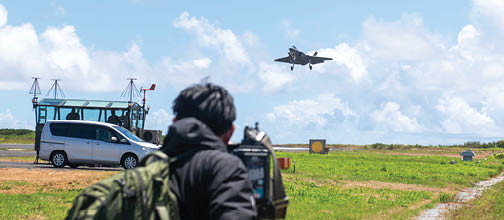 250525-N-NA545-1006 IWO TO, Japan (May 25, 2025) Japanese media representatives capture a U.S. Navy F-35C Lightning II assigned to Strike Fighter Squadron (VFA) 147 and attached to Carrier Air Wing (CVW) 5 as the aircraft conducts a “touch-and-go” during a field carrier landing practice (FCLP) at Iwo To, Japan, May 25, 2025. FCLP is a required flight training for pilot qualification and proficiency that precedes aircraft carrier landing operations, ensuring warfighting readiness in support of regional security and stability in the U.S. Indo Pacific region. (U.S. Navy photo by Mass Communication Specialist 2nd Class Dyxan K. Williams)