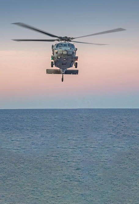 250701-N-WJ234-1950 CORAL SEA (July 1, 2025) An MH-60S Seahawk from Helicopter Sea Combat Squadron (HSC) 25 prepares to land on the flight deck of the forward-deployed amphibious assault ship USS America (LHA 6) while conducting flight operations in the Coral Sea, July 1. America, lead ship of the America Amphibious Ready Group, is operating in the U.S. 7th Fleet area of operations. U.S. 7th Fleet is the U.S. Navy’s largest forward-deployed numbered fleet, and routinely interacts and operates with allies and partners in preserving a free and open Indo-Pacific region. (U.S. Navy photo by Mass Communication Specialist Seaman Sam McNeely)
