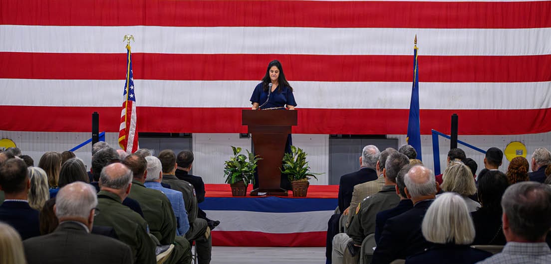 The wife of the late Lt. Cmdr. Raymond O’Hare delivers remarks during a ceremony dedicating a new test facility in her husband’s name. The hangar, which will support the MQ-25A Stingray program, honors O’Hare, a U.S. Naval Test Pilot School alumnus who died in a training accident in 2000. (U.S. Navy photo by Todd Frantom)