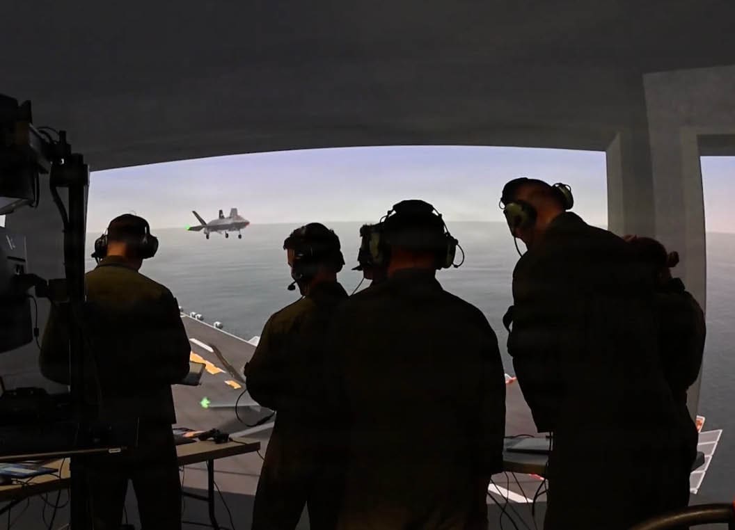 U.S. Marine Corps Landing Signal Officers monitor a simulated F-35B Lightning II recovery inside the Manned Flight Simulator at the Naval Air Warfare Center Aircraft Division in Patuxent River, Md. The warfare center is serving as the interim schoolhouse for a new Marine Corps program that trains and certifies Landing Signal Officers for the unique short takeoff and vertical landing procedures of the F-35B. The school, which will also train international partners, is a critical step to standardize operations and enhance interoperability across the global F-35B fleet. (U.S. Navy photo by Chuck Regner)
