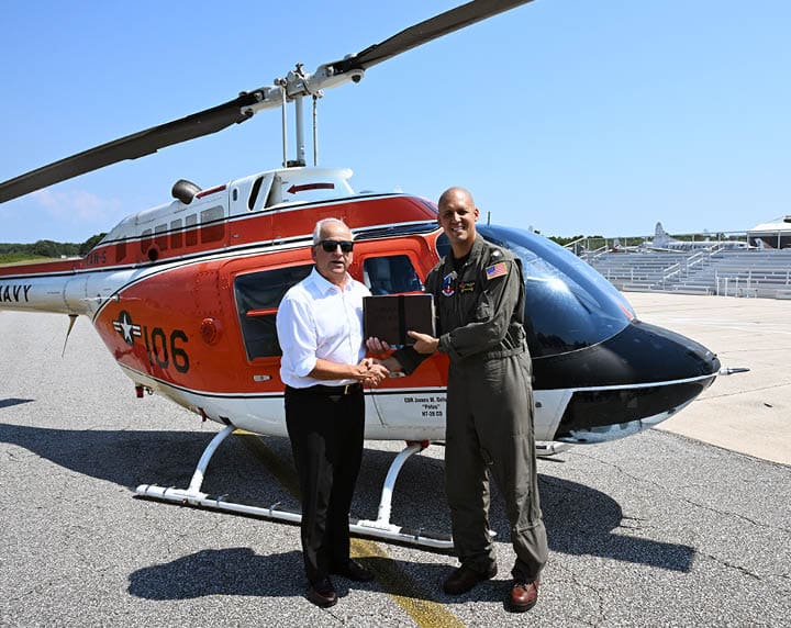 Cmdr. James Gelsinon, commanding officer, Helicopter Training Squadron Twenty Eight (HT-28), right, presents a TH-57C Sea Ranger aviation log book to Sterling Gilliam, director, Naval Aviation Museum, on Sept. 19, 2025. Gelsinon, along with Lt. Cmdr. Mike Allert, instructor pilot for HT-28, flew the aircraft from Training Air Wing FIVE at Naval Air Station Whiting Field to the National Naval Aviation Museum in Pensacola, Fla., for transfer for induction into the museum’s inventory. After 57 years of service training Navy, Marine, and Coast Guard aviators, the TH-57 has been replaced by the TH-73A Thrasher, marking new and advanced training for rotary training. (U.S. Navy photo by Christy Mason)