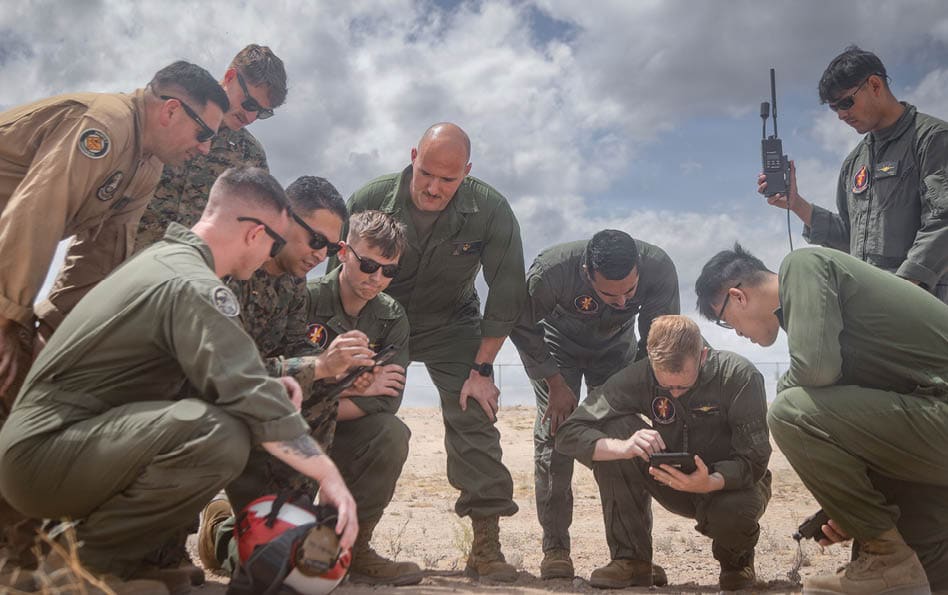 U.S. Marines assigned to Marine Aviation Weapons and Tactics Squadron One (MAWTS-1) have a group discussion as part of Weapons and Tactics Instructor Course 2-26 at Marine Corps Air Station Yuma, Arizona, April 13, 2026. WTI is a seven-week training event hosted by MAWTS-1 which emphasizes operational integration of the seven functions of Marine aviation in support of the Marine Air Ground Task Force, Joint and Coalition Forces. (U.S Marine Corps photo by Lance Cpl. Fabian Ortiz)