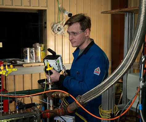 Nicholas Diskerud, Ph.D., NRC postdoctoral research associate, focuses a high-speed camera on an optically-accessible solid-fuel slab burner at the U.S. Naval Research Laboratory’s (NRL) Combustion Lab in Chesapeake Beach, Maryland, Jan. 15, 2026. Researchers and engineers at NRL use an optically-accessible solid-fuel slab burner to perform combustion experiments at conditions relevant to solid-fuel ramjet flight. (U.S. Navy photo by Jonathan Sunderman)