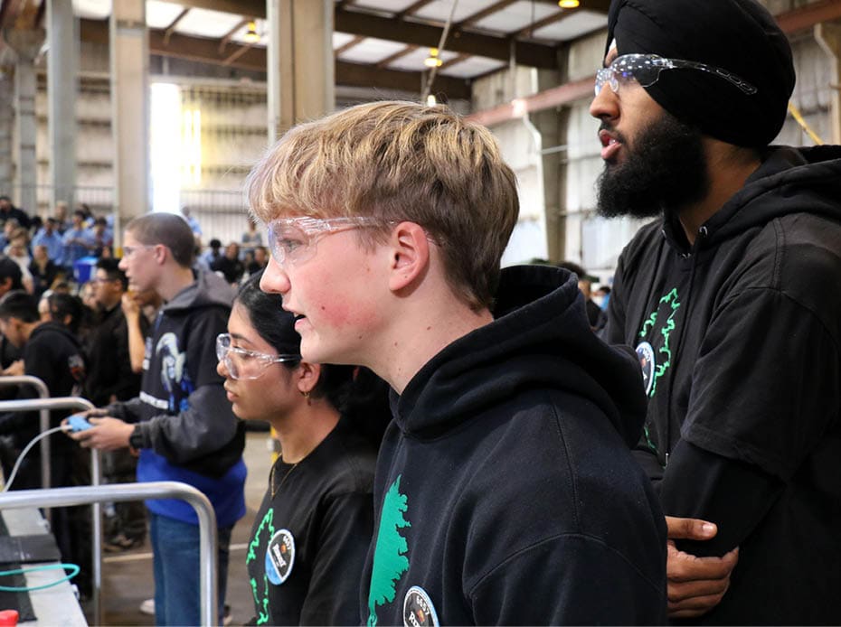 The drive team for Team 6657, the Arborbotics, operate their robot from the alliance station during a qualification match at the California District Hueneme Port Event at FATHOMWERX in Port Hueneme, Calif., March 8. 