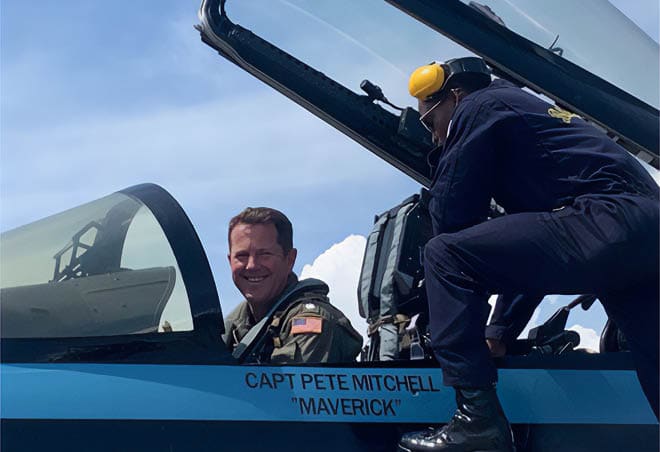 Two men are in a cockpit of a plane, one is smiling. AI generated content