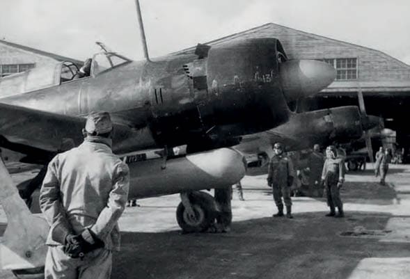 A black airplane is parked on the ground with a man standing next to it. AI generated content