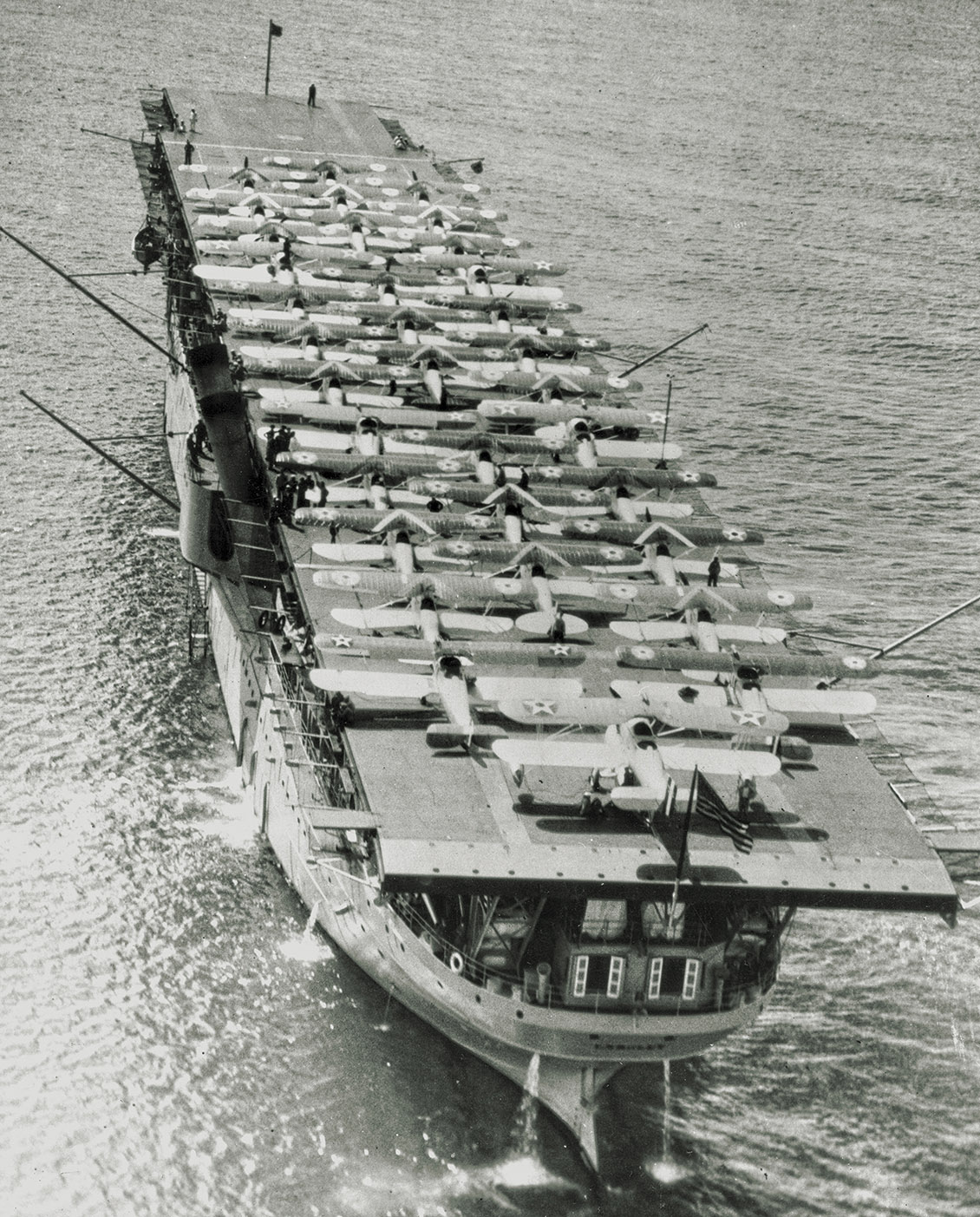 USS Langley (CV 1) in Pearl Harbor with 34 planes on her flight deck, May 1928.